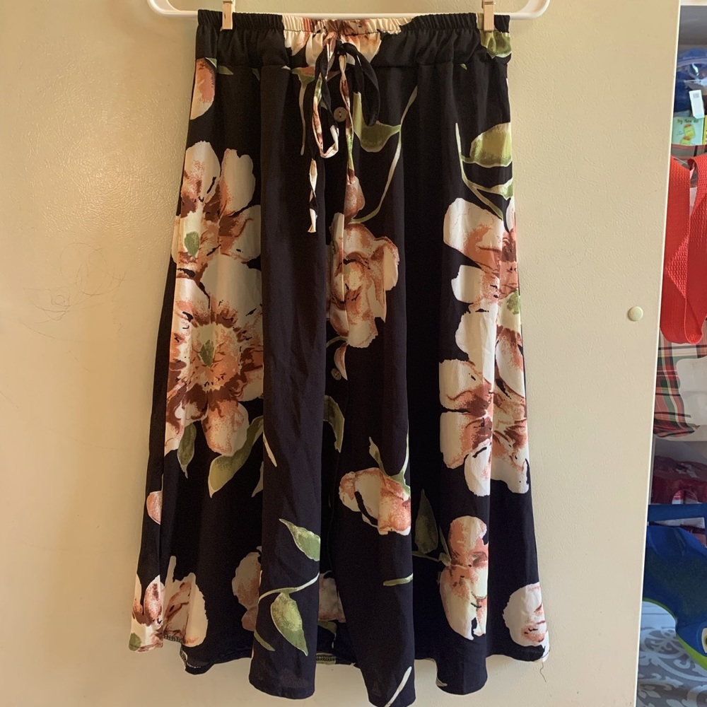 Black floral skirt with elastic waist, fake tie, and fake buttons